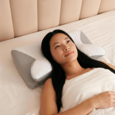 Woman lying back resting on the Solvrly Ergonomic Pillow