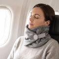 Woman sleeping upright on a plane wearing the Solvrly Wrap Travel Pillow