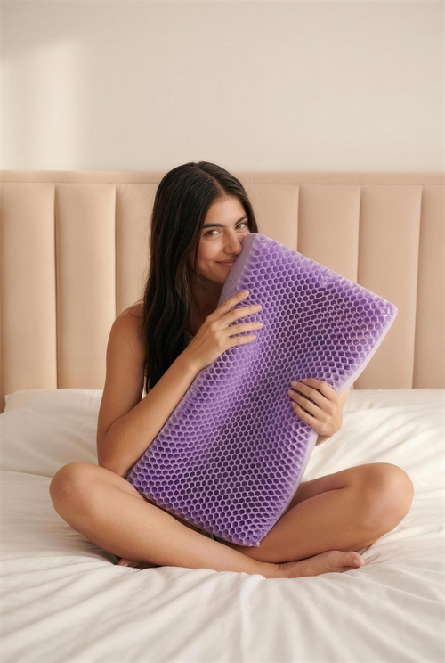 Woman holding the Solvrly Honey Comb Cooling Pillow in bed
