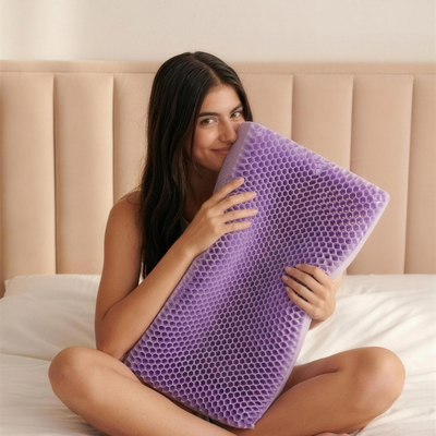 Woman holding the Solvrly Honey Comb Cooling Pillow in bed