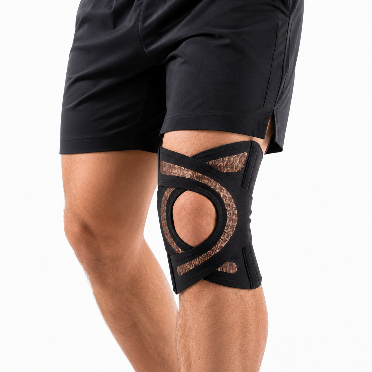 The Solvrly Pivot knee brace in black worn under shorts, showing the bronze jacquard side panels